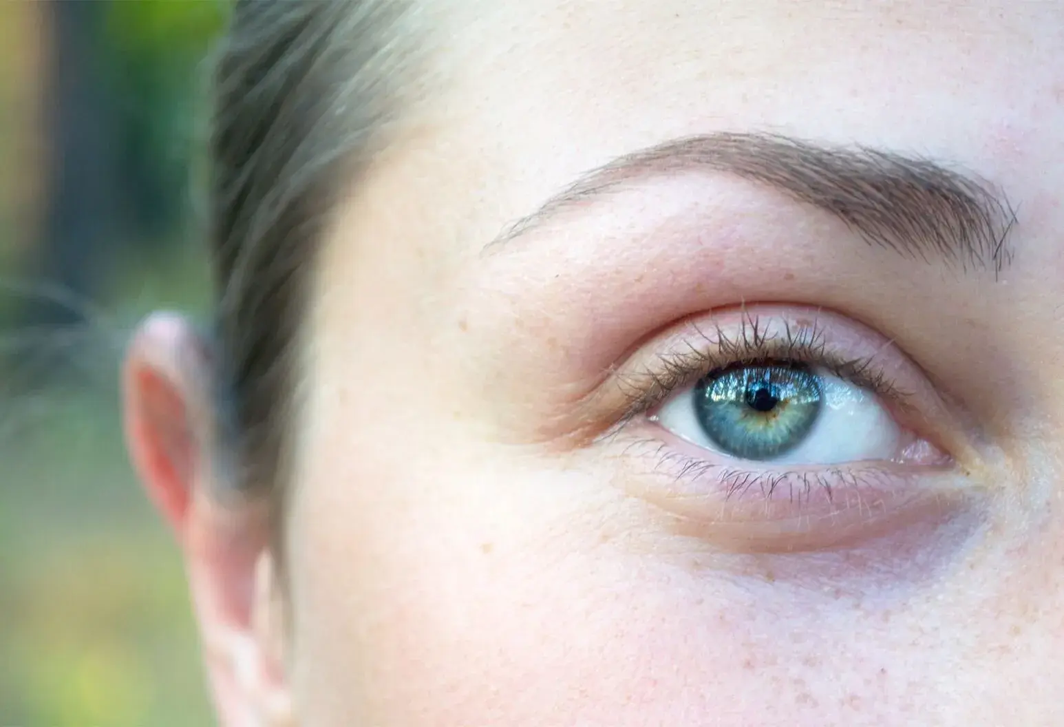 Close-up of a blue eye with clear details and light reflections.