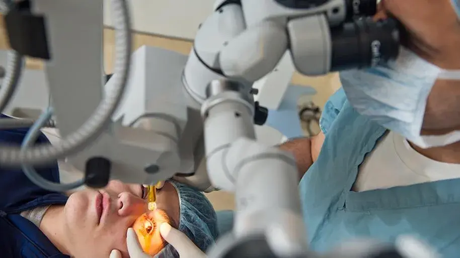 Surgeon performing corneal cross-linking surgery on a patient.
