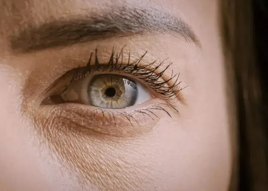 Close-up of a human eye showing the iris, pupil, and eyelashes.