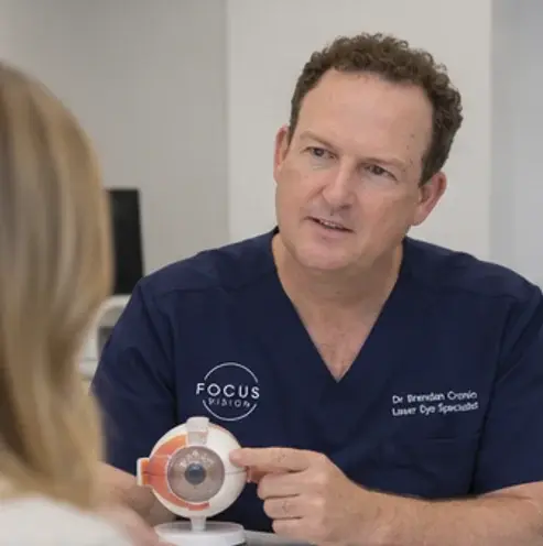 Dr Brendan Cronin explaining corneal anatomy to a patient using an eye model