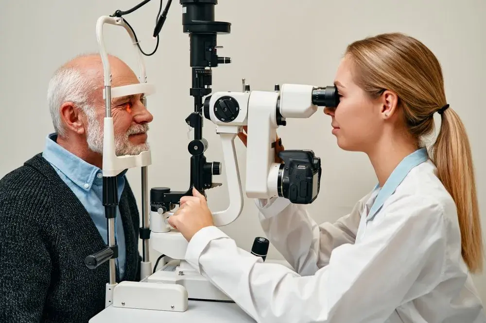 Ophthalmologist examining a male patient during an eye exam.