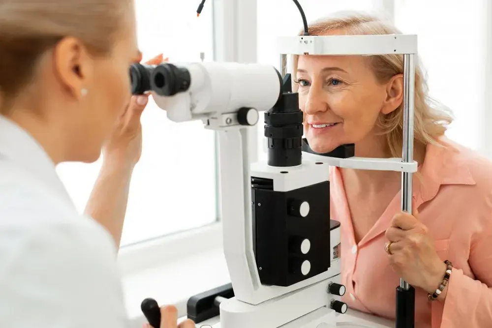 Patient undergoing an eye examination with a slit lamp by an ophthalmologist.