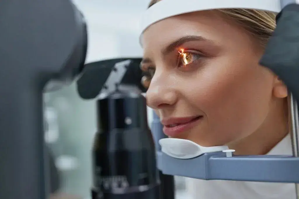 Close-up of a female patient during an eye examination with a medical device.