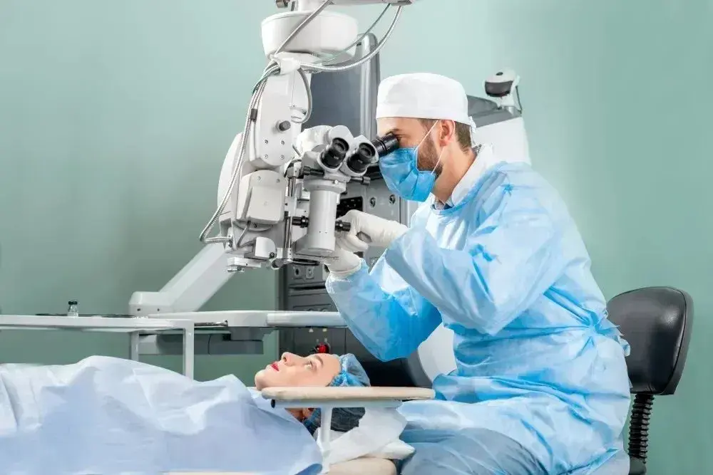 Doctor examining a patient with an eye examination device in a clinical setting.