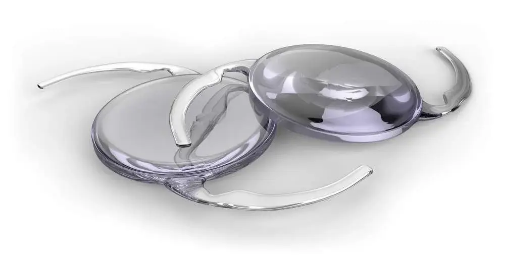 Two clear intraocular lens implants displayed on a white background.