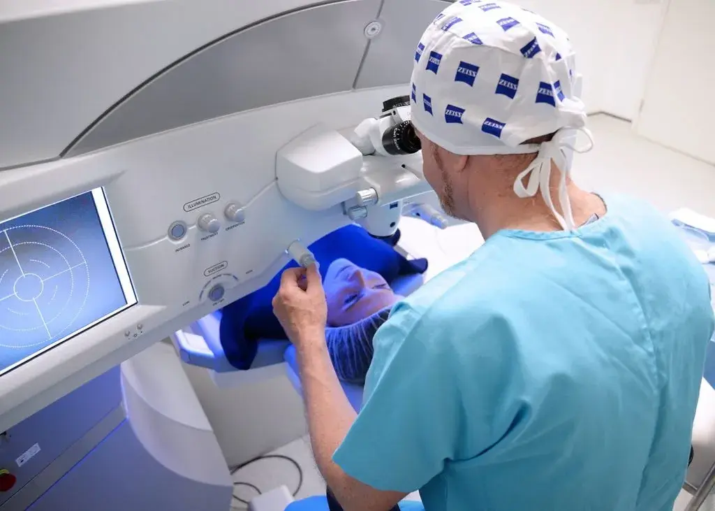 Ophthalmologist performing laser eye surgery on a patient using advanced equipment.