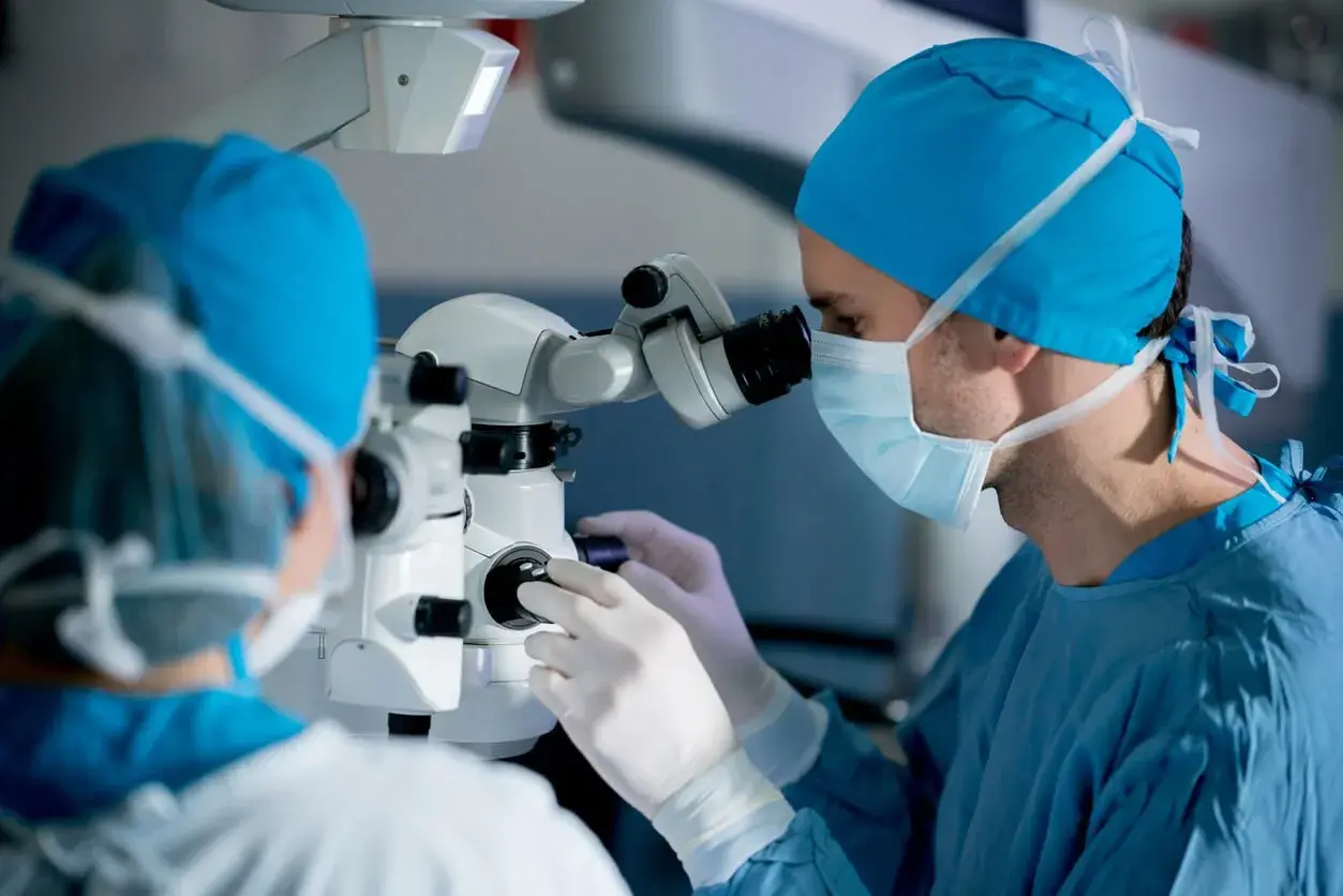 Surgeon using a microscope during laser eye surgery.