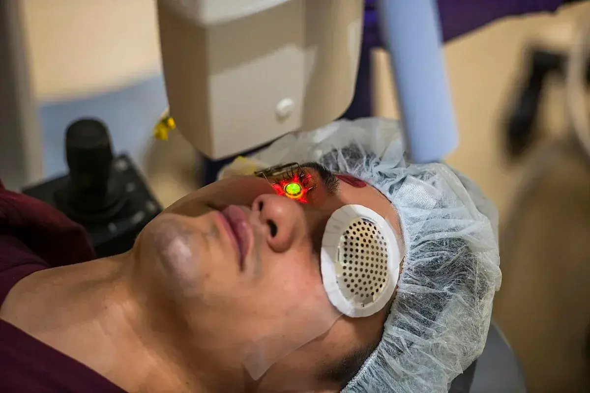 Patient undergoing laser eye treatment with protective eyewear.